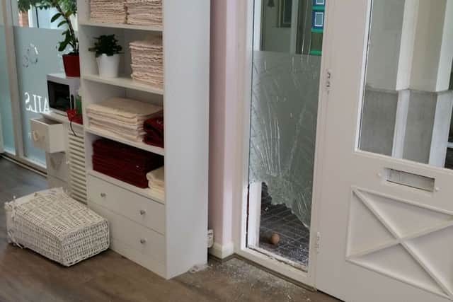 The smashed window where burglars forced entry into the JN Nails business in the Bell Centre in Melton EMN-171007-152743001