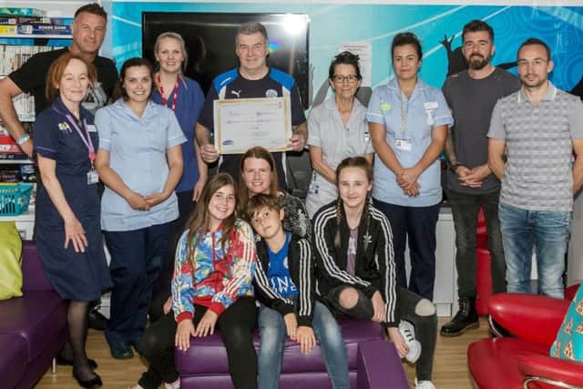 Leicester City FC legends with staff members from Ward 27, the teenage cancer trust unit, at Leicester Royal Infirmary:From left, back rowr: L-R Steve Walsh, Tom Naughton (legends manager), Muzzy Izzet, Chris Edwards (Jessica's dad);Front row, Violet Edwards (Jessicas sister), Leanne Edwards (Jessicas mum), Richey Edwards (Jessicas brother), Isabelle Edwards (Jessicas sister) EMN-170607-164701001