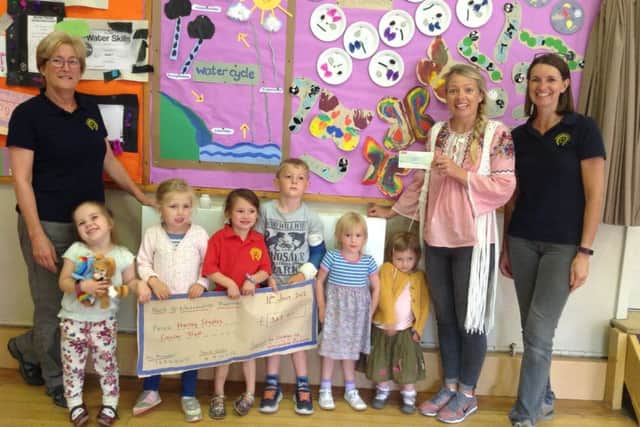 Children present the funds they raised to Harley's mother Katherine PHOTO: Supplied