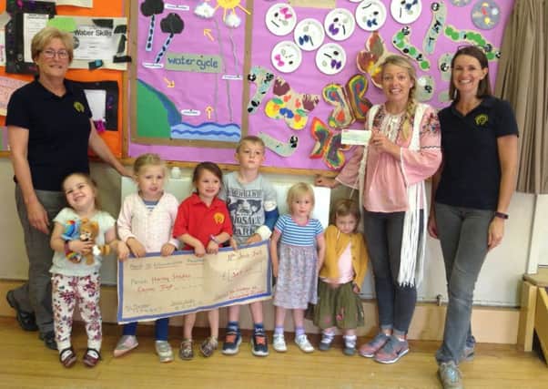 Children present the funds they raised to Harley's mother Katherine PHOTO: Supplied