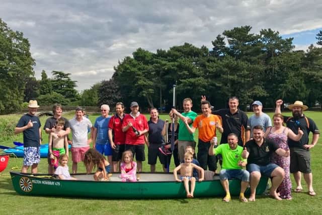 Back on dry land, teams pose with a canoe from the race PHOTO: Supplied