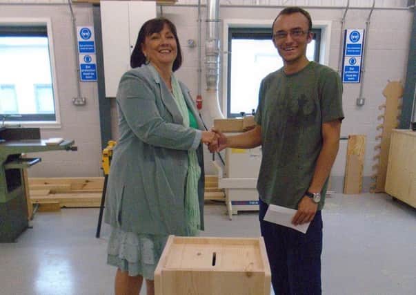 Karen Riley from the Skills Funding Agency with Brooksby Melton College joinery apprentice Sam Coxon PHOTO: Supplied