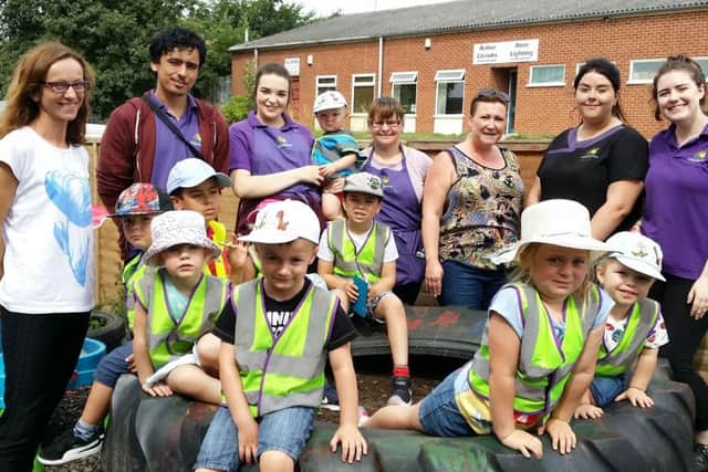 Owner Joanna Kavanagh with some of her staff and children in the back yard at Melton Creche Services EMN-170718-181145001