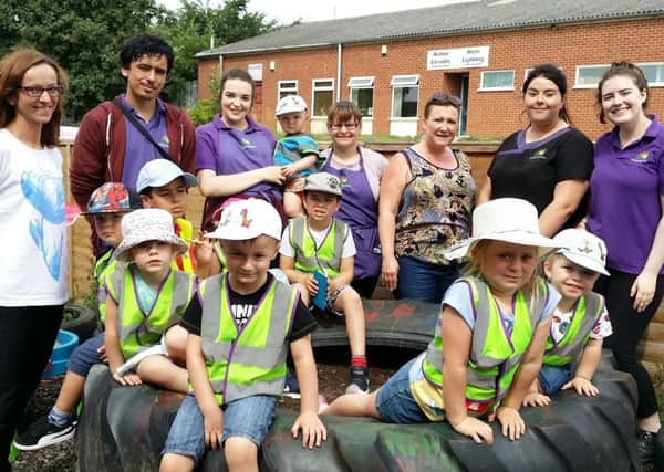 Owner Joanna Kavanagh with some of her staff and children in the back yard at Melton Creche Services EMN-170718-181145001