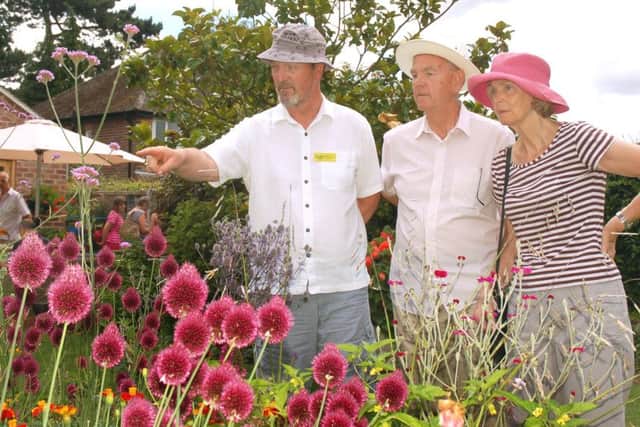 Garden owner Richard Lawrence shows guests Roger and Irene Peutrill around PHOTO: Tim Williams