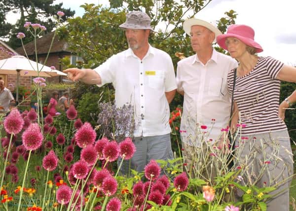 Garden owner Richard Lawrence shows guests Roger and Irene Peutrill around PHOTO: Tim Williams