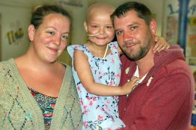 Evie Moore, who is recovering from a bone marrow transplant, with parents Chris and Helena EMN-170724-140009001