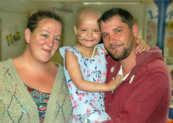 Evie Moore, who is recovering from a bone marrow transplant, with parents Chris and Helena EMN-170724-140009001
