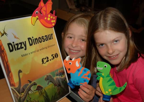 Sisters Scarlett and Holly Measures get set to go dinosaur racing PHOTO: Tim Williams