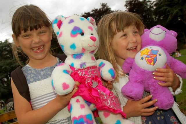 Sisters Ruby and Elsie Leake enjoy the picnic with their cuddly friends PHOTO: Tim Williams