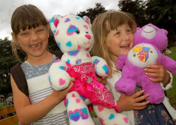 Sisters Ruby and Elsie Leake enjoy the picnic with their cuddly friends PHOTO: Tim Williams