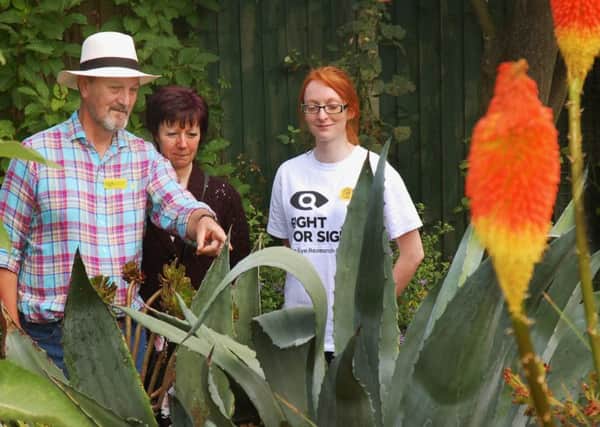 Richard Lawrence shows Shirley Freer and Rebecca Ingle around 
a border of Agave and Red Hot Poker PHOTO: Tim Williams
