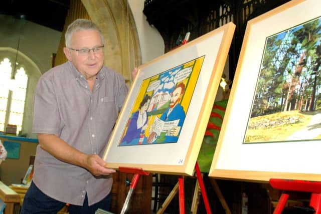 Geoff Collier with examples of his oils and ink artwork PHOTO: Tim Williams