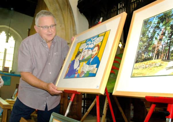 Geoff Collier with examples of his oils and ink artwork PHOTO: Tim Williams