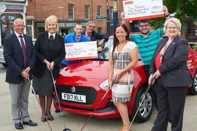Main sponsors in Meltons Market Square with the Suzuki Swift star prize. From left  Stephen Jeal (NFU Mutual), Jenny Barnes (Richard Barnes Funeral  Directors), Justin Masters (Browning Suzuki), competitino organiser Derek Whitehouse, Melanie Swainston (Melton Mowbray Building Society), Joe Dixon (TTS Shipping) and Lions president Brina Tate EMN-170108-144252002