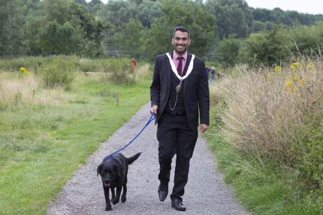 EDITORIAL USE ONLY
Melton Lord Mayor Cllr Tejpal Bains and Labrador Poppy celebrate the opening of a new dog activity trail in Melton Country Park in Leicestershire, which has been installed as part of the pet-friendly initiatives being rolled out by the local council and Mars Petcare. PRESS ASSOCIATION Photo. Picture date: Tuesday July 25, 2017. New research of 2,500 pet and non-pet owners across the world found that pets bring communities together and strengthen ties with our neighbours. Photo credit should read: Lucy Ray/PA Wire EMN-170726-172321001