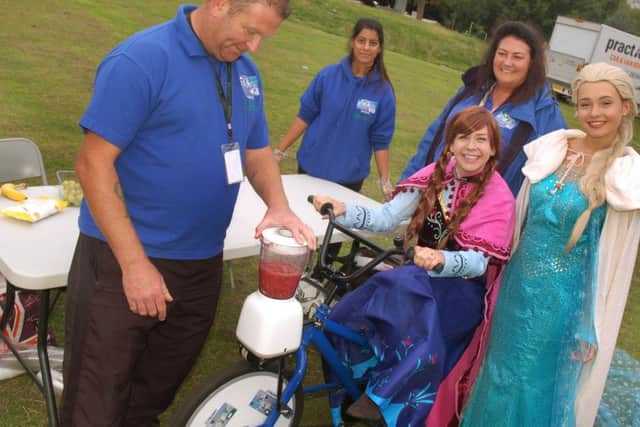 Mary Garve and Olivia Bailey from Princess Pals try out the Smoothie making bicycle run by the Leicestershire Youth Offending Service PHOTO: Tim Williams