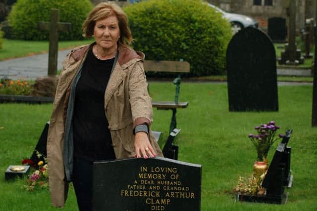 Jennifer Hughes by her father's gravestone in Melton's Thorpe Road cemetery - her car is visible in the background where it was parked when someone smashed the window to steal her handbag EMN-170808-133041001