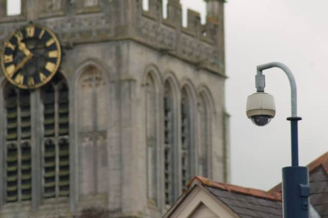 The police CCTV camera in Market Place, Melton, with historic St Mary's Church behind EMN-170708-162116001