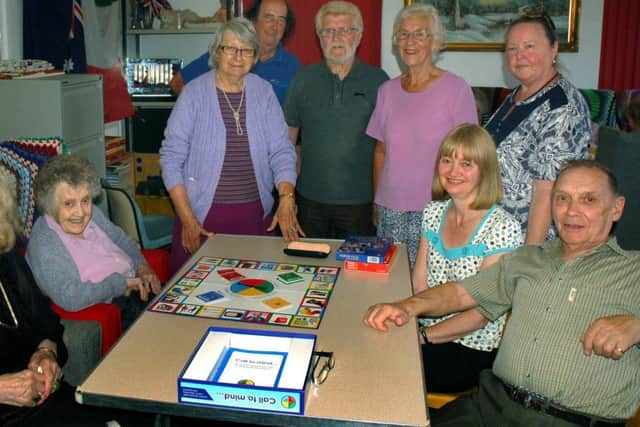 Gloucester House day care organiser Pam Wright (back row, right) with volunteers, carers and their relatives at a dementia care session EMN-170815-160557001