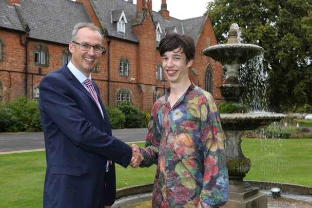 Ratcliffe College A-level student Charlie Nicholson, who achieved four A* grades and full marks in maths and further maths, with headmaster Jon Reddin EMN-170817-125731001