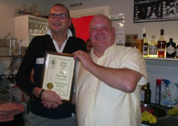 Melton CAMRA chairman Kevin Billson presents Tim Giddens with a Merit Award PHOTO: David Eatherington