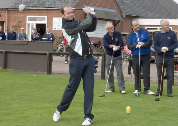 From left, Geordan Murphy swings as Melton GC captain Ian Solloway, Tigers club physio Bobby Sourbuts and Melton GC chairman Phil Millward look on EMN-170919-162217002