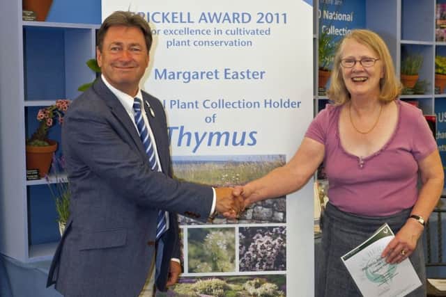 Margaret Easter receiving the Brickell Award for Excellence in Cultivated Plant Conservation with gardening icon and Plant Heritage president, Alan Titchmarsh PHOTO: Tim Easter