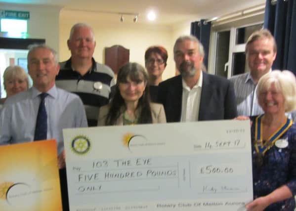 Aurora Rotarians present a cheque for Â£500 to 103 The Eye PHOTO: Supplied