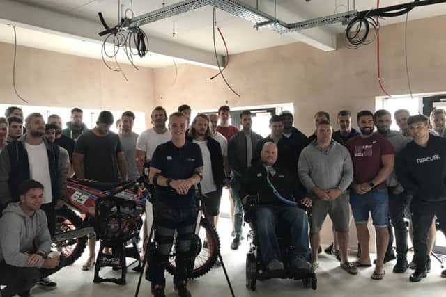 Spencer Watts (left centre), a beneficiary, with Matt Hampson (right centre) and the Leicester Tigers team at the Get Busy Living Centre PHOTO: Supplied