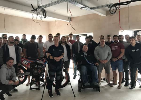 Spencer Watts (left centre), a beneficiary, with Matt Hampson (right centre) and the Leicester Tigers team at the Get Busy Living Centre PHOTO: Supplied