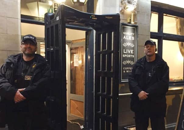 Police officers with a knife arch metal-detector outside the Black Swan pub in Melton which was deployed as part of an operation to raise awareness about the dangers of carrying knives EMN-170910-101209001