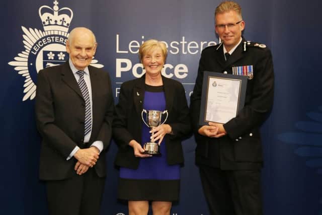Gill Becken is presented with the 'police support volunteer of the year' award by Leicestershire Chief Constable Simon Cole EMN-171013-122219001