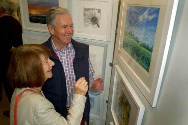 Keith Jones bought one of Angela Shaw's pastel landscapes PHOTO: Tim Williams