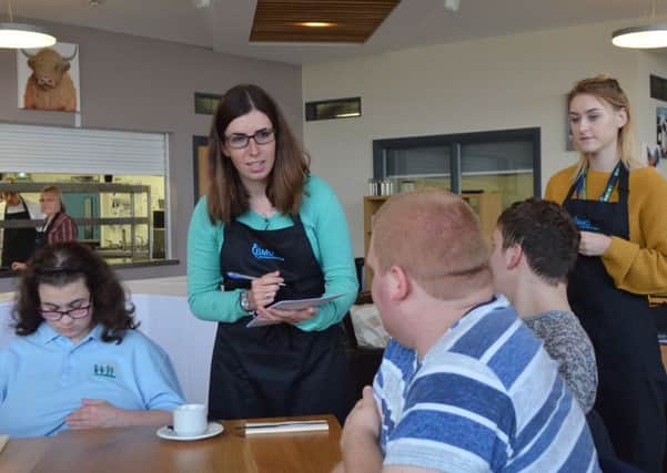 Sophie Garfoot (green jumper) taking orders from the Birch Wood School sixth form students PHOTO: Supplied