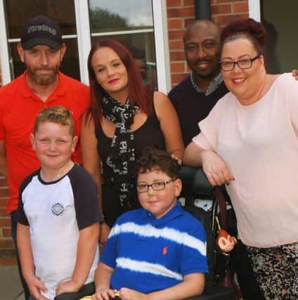 Karen Dack with sons William (11) and Finlay (7) and her friend Natalie Brown, who organised a DIY SOS campaign to redesign the back garden, William's father Billy and Karen's partner, Emmanuel Akamo are also in the picture. A fundraising football match is planned at Asfordby. EMN-170911-111229001
