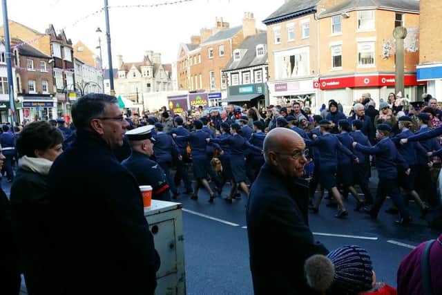 Large crowds watch the Remembrance Sunday parade move through Market Place in Melton this morning EMN-171211-125939001