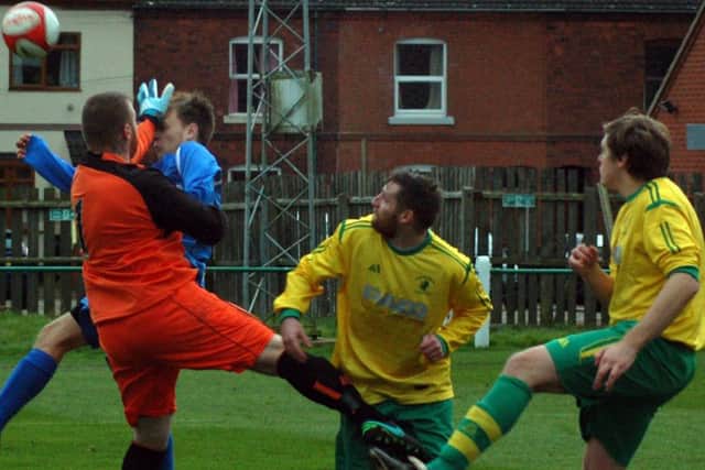 Jamie Witham challenges while David Hazeldine and Rob Woodcock look on as Holwell mount a successful rearguard action against Belper EMN-171120-110539002