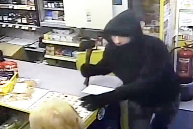 CCTV footage at Craven Street Stores showing Neil Gordon brandishing an axe while confronting store part-owner Ann Sage. EMN-171117-145310001