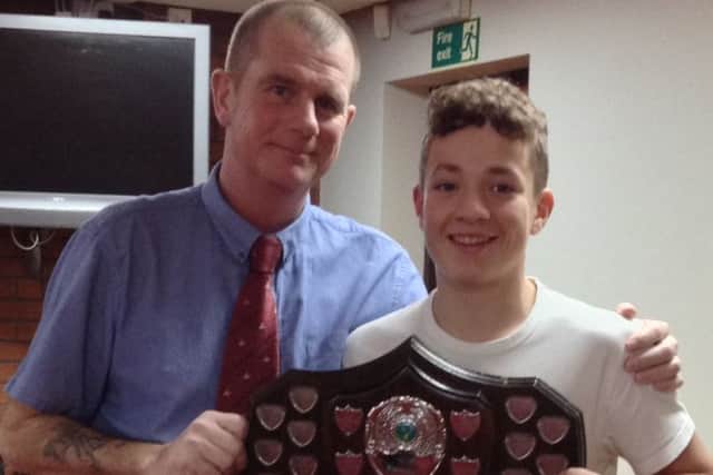 Club captain Martin Harvey presents junior captain Tom Rawson with the Lincolnshire South Junior League winners shield EMN-171122-124140002